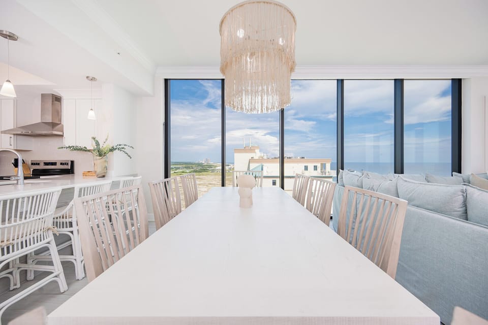 Dine at the spacious table, surrounded by large windows that offer beautiful views of the beach