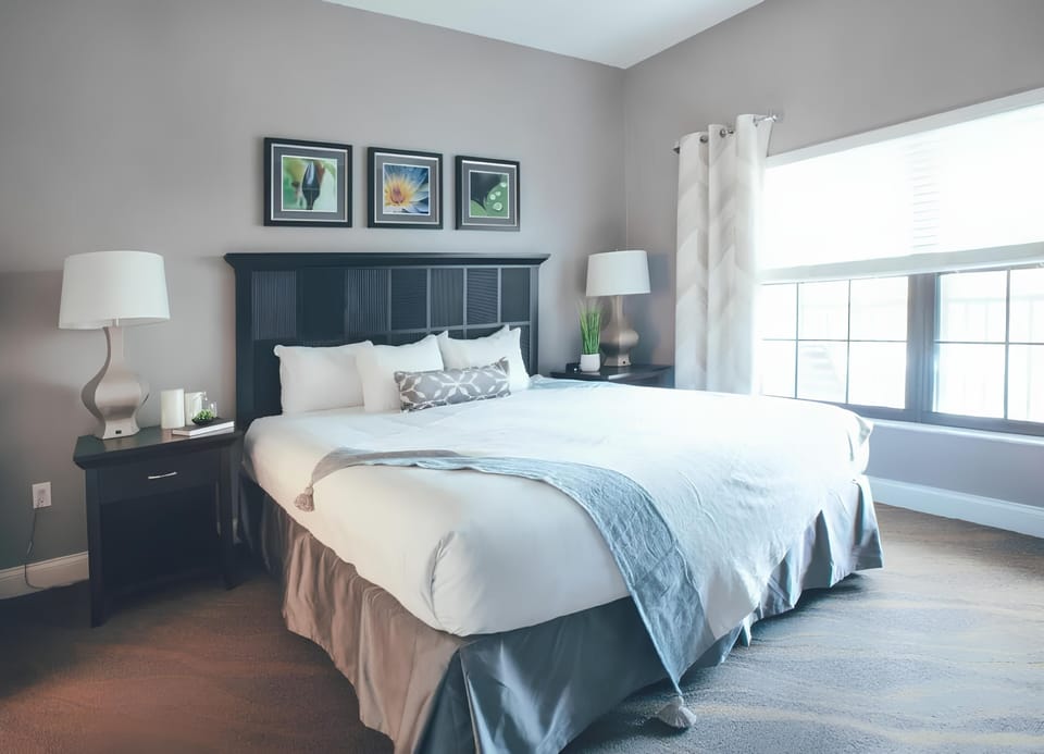 Unwind in a sunlit king bedroom with plush linens.