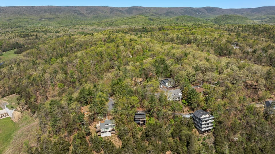 From above, see how this beautiful home blends seamlessly into the breathtaking mountain landscape.