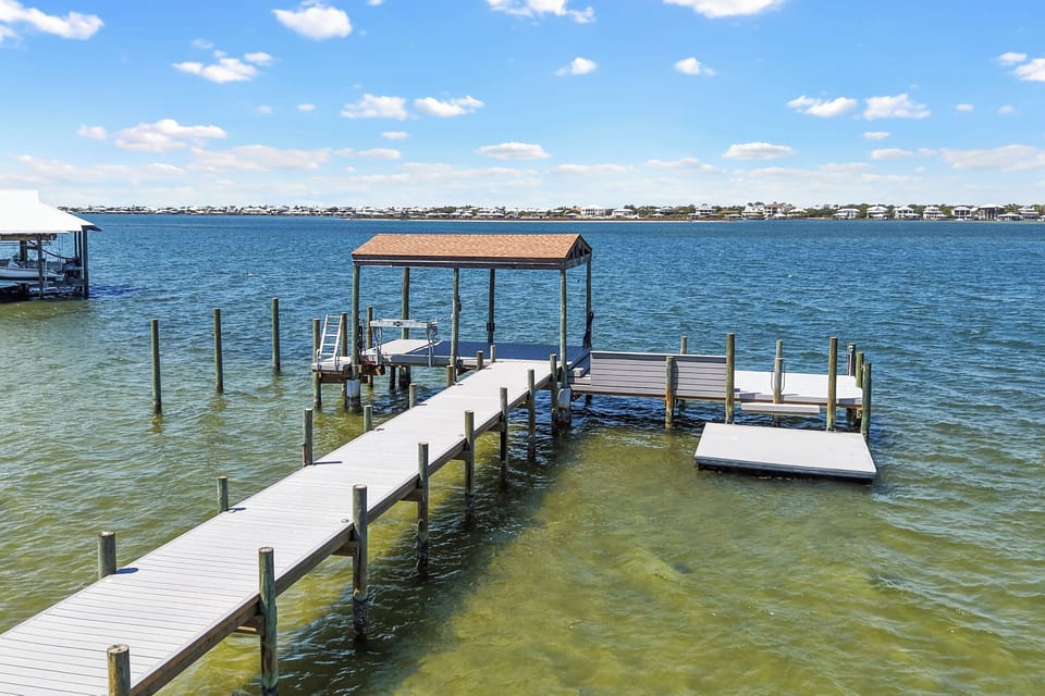Private dock with fish cleaning station and multiple boat parking spots.