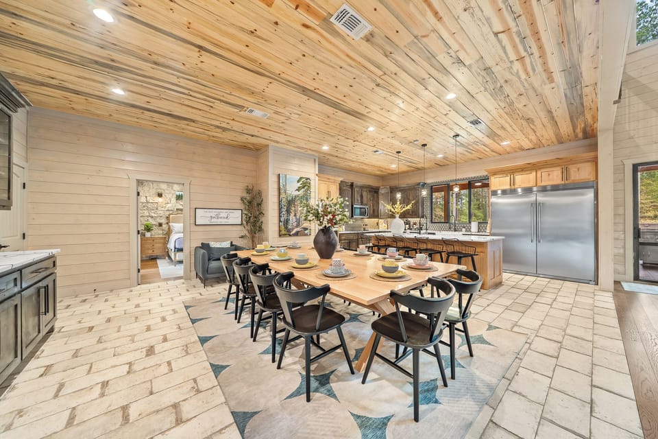 Large kitchen with custom table + counter seating. Commercial fridge, double sinks, dishwashers, trash cans, pantry and more!