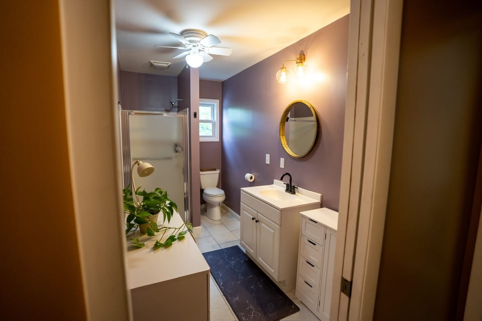 This spa-like bathroom offers a walk-in shower/ample counter space/fresh towels