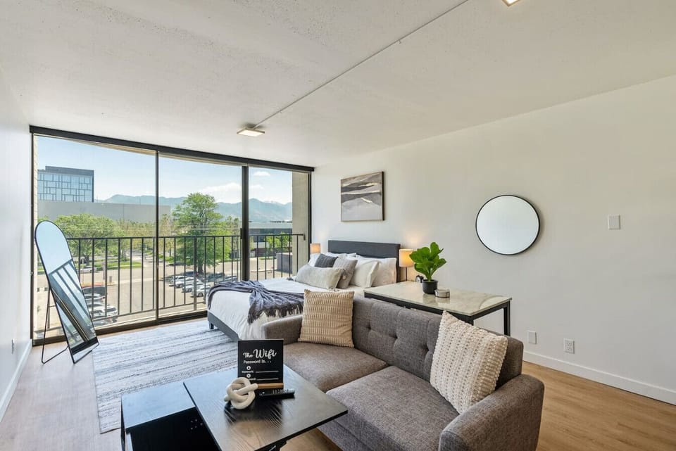 Inviting living room w/ comfy sofa & balcony access for fresh air & views