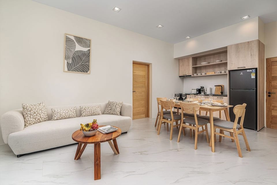 The living room is designed for relaxation and entertainment, featuring a smart TV that provides access to international channels and popular streaming services. 