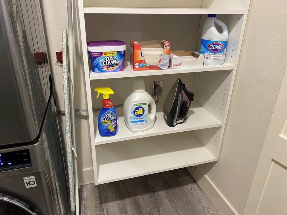 Laundry supplies, iron and ironing board.