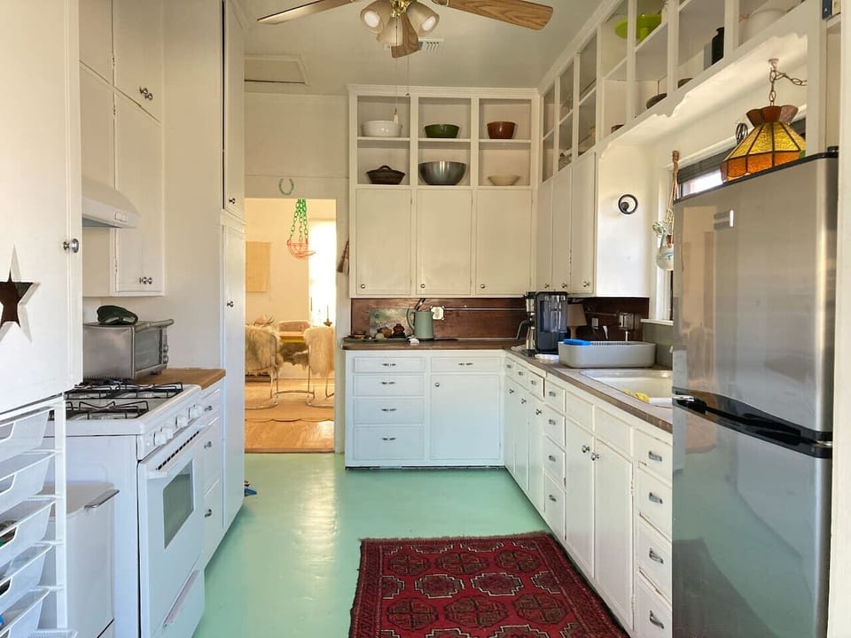 Kitchen features a coffee maker,  toaster oven and plenty to cook with.