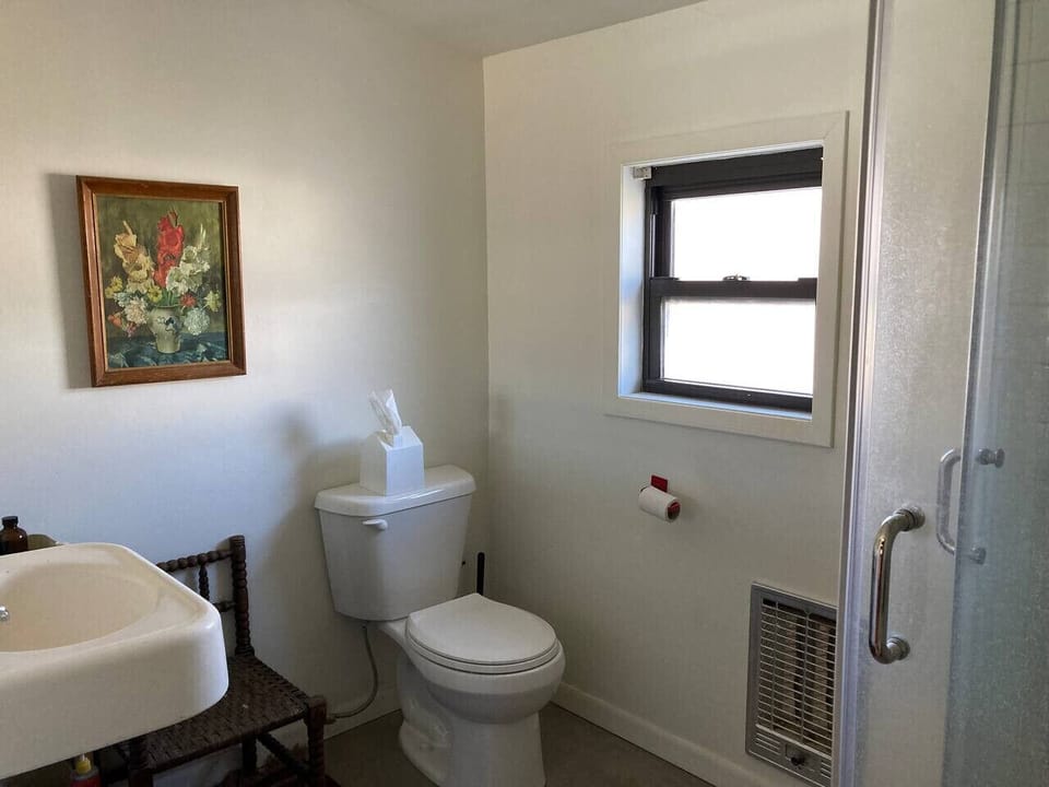 Second bedroom`s bathroom featuring glass-encased shower. Original sinks from the Paisano Hotel.