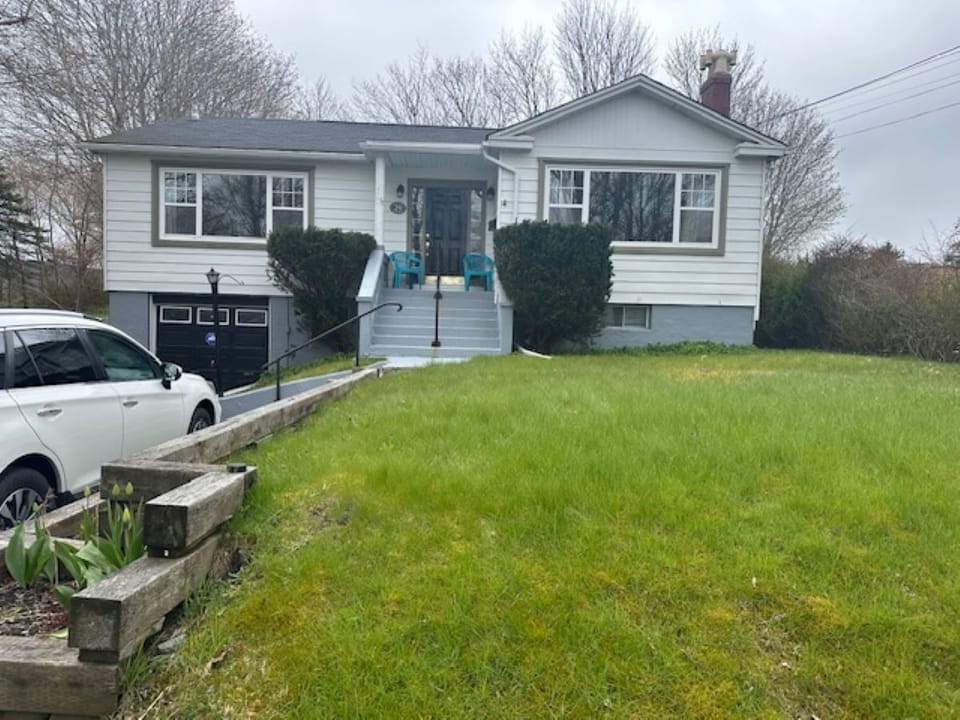 Stylish 3BR home in St. John's featuring a welcoming front porch, spacious yard, and attached garage—perfect for family living.