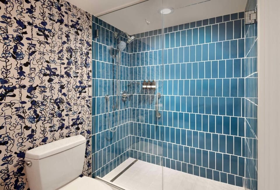 Rinse off in the sleek glass shower with spa-like tiles.