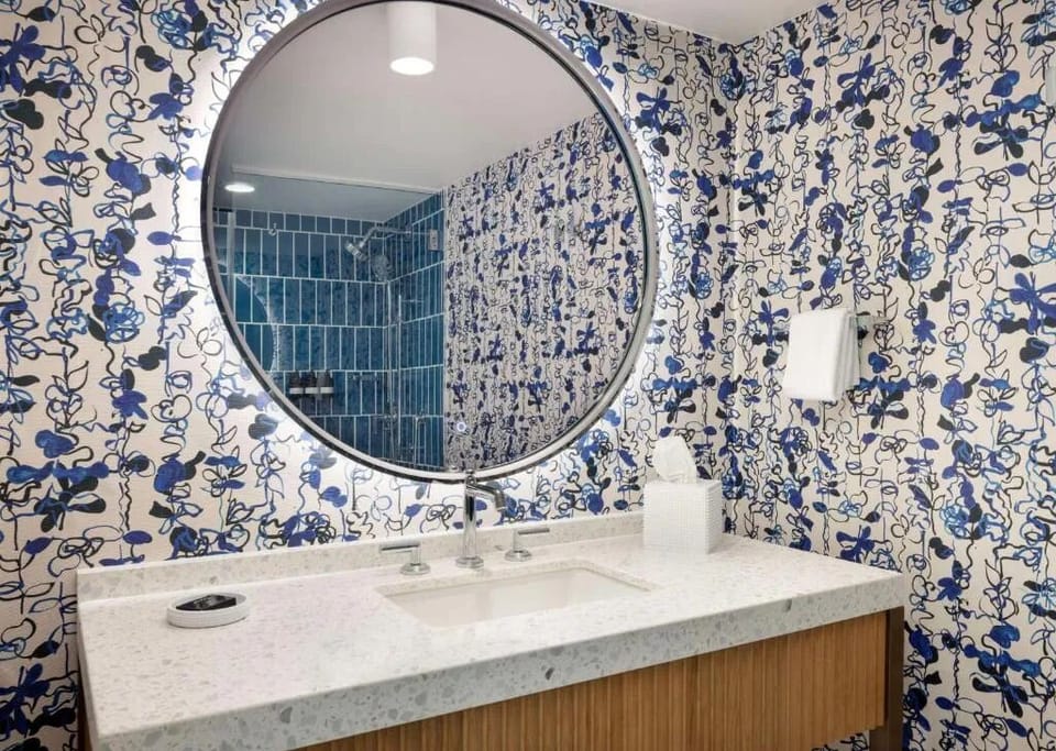 Refresh at the designer vanity with bright mirror lighting.