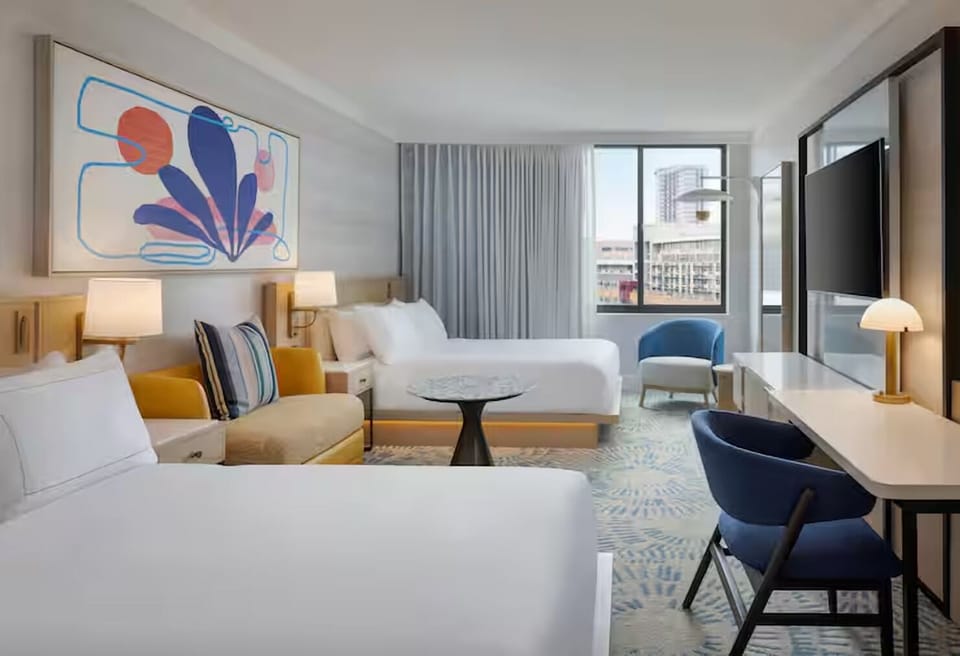 Settle into airy comfort with skyline views and plush beds.