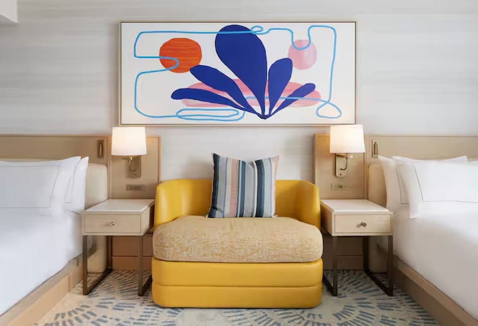 Sink into crisp linens framed by bold, modern artwork.