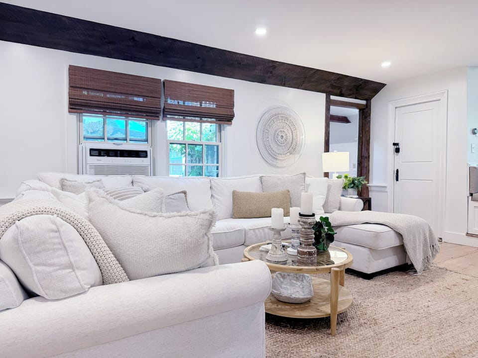 Living room area with access to dining area and sitting area.