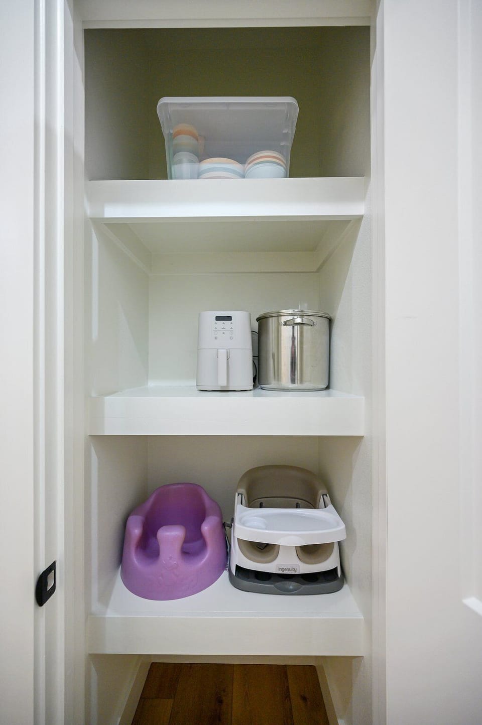 In our pantry you will find some things for the littles...kid's dishes, Bumbo seat & Booster Feeding Chair. We also keep a large soup pot, Bella air fryer and our crockpot which is not pictured here. 