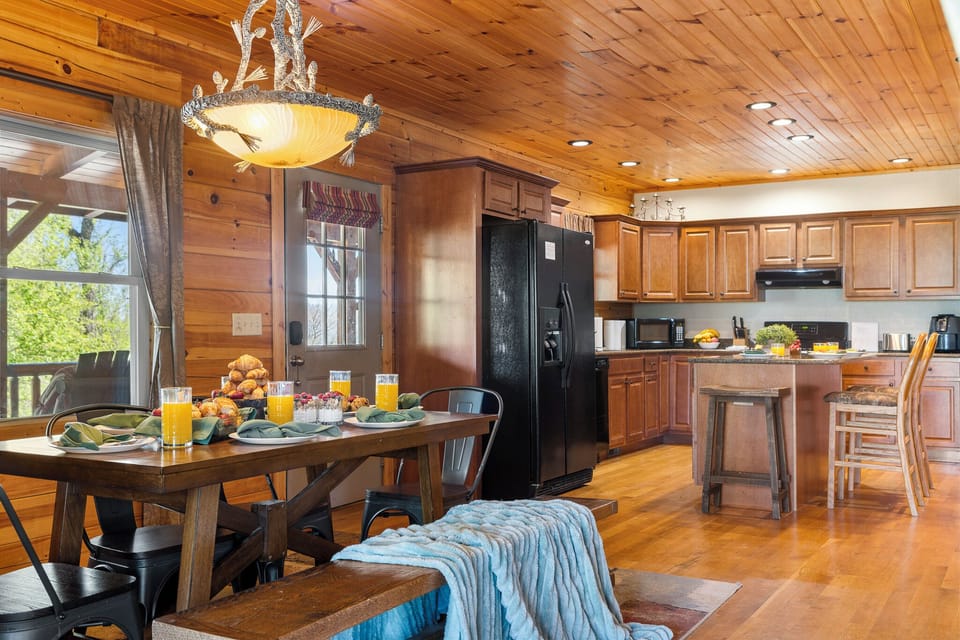 Dining Room: Savor meals at a stunning wooden table under a charming chandelier with mountain views!