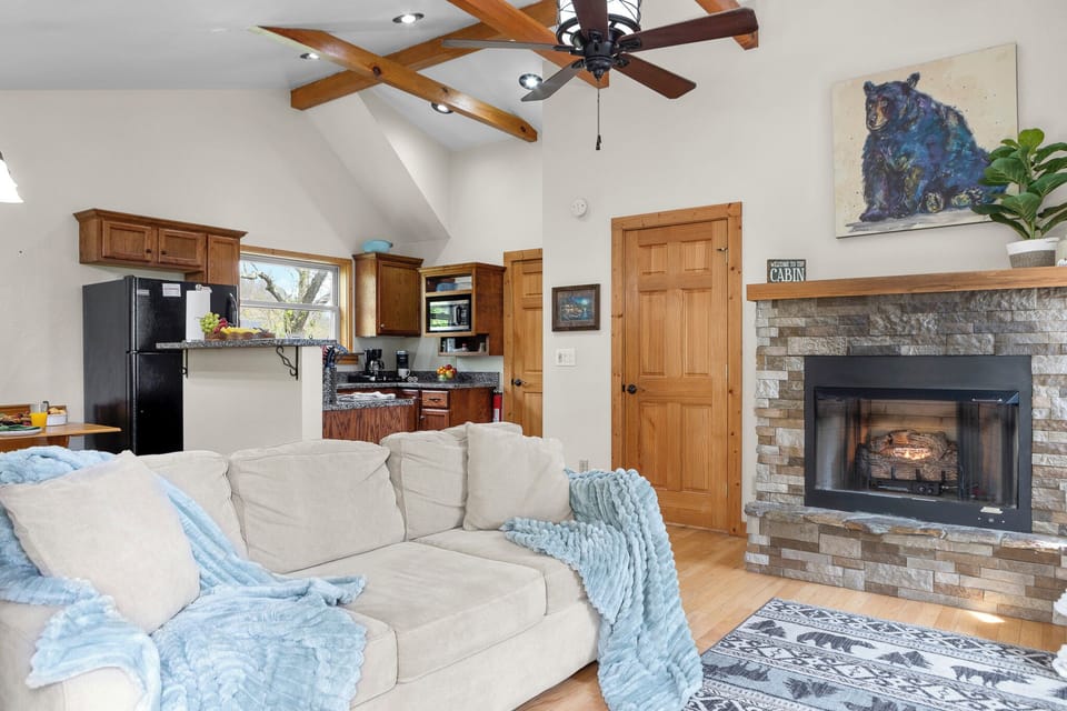 Living Room Retreat: Spacious area with comfy seating, a cozy fireplace, and rustic charm await you!