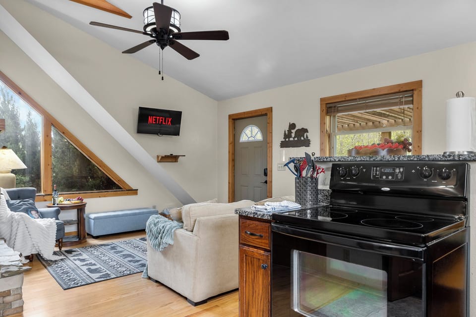 Living Room: Sunlit comfort with a smart TV and sweeping views—perfect for relaxation and fun!