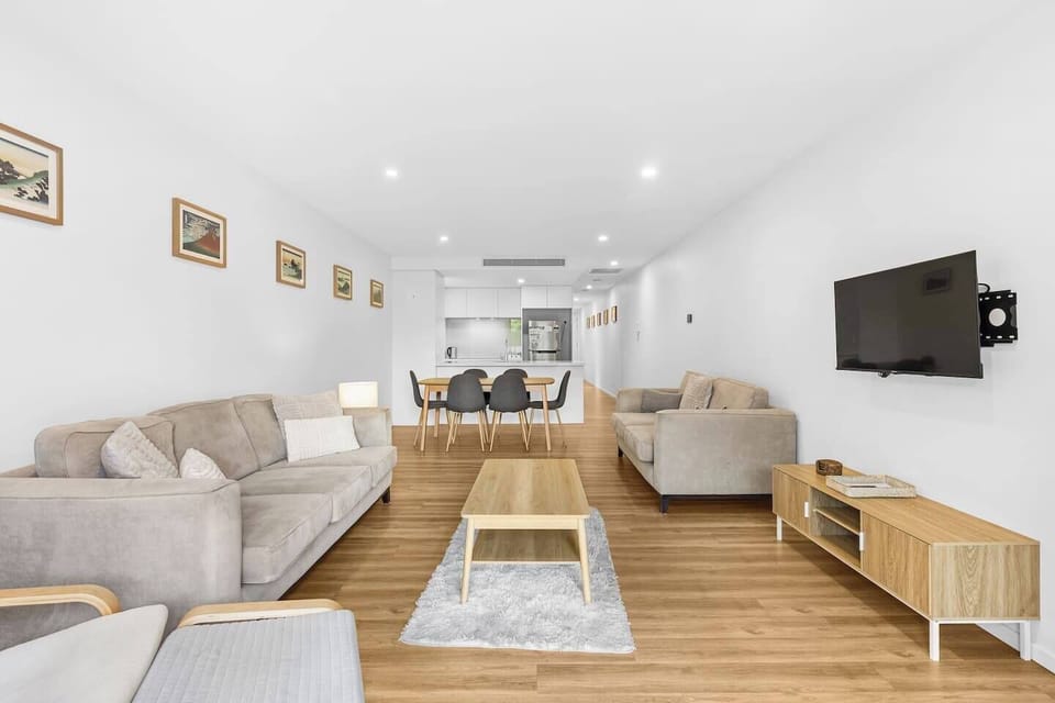 Sink into a soft sofa or plush armchairs in the sunlit living area, an inviting area to unwind with your favourite show on the wall-mounted TV.