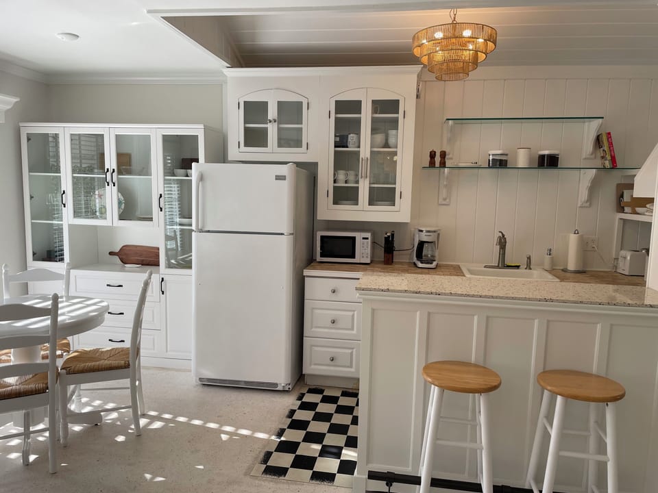 Kitchen, bar seating and dining area