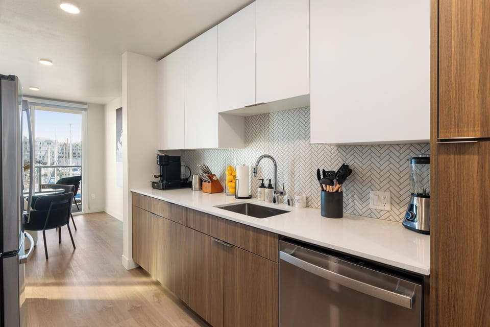 Fully stocked kitchen with sleek finishes and harbor views

