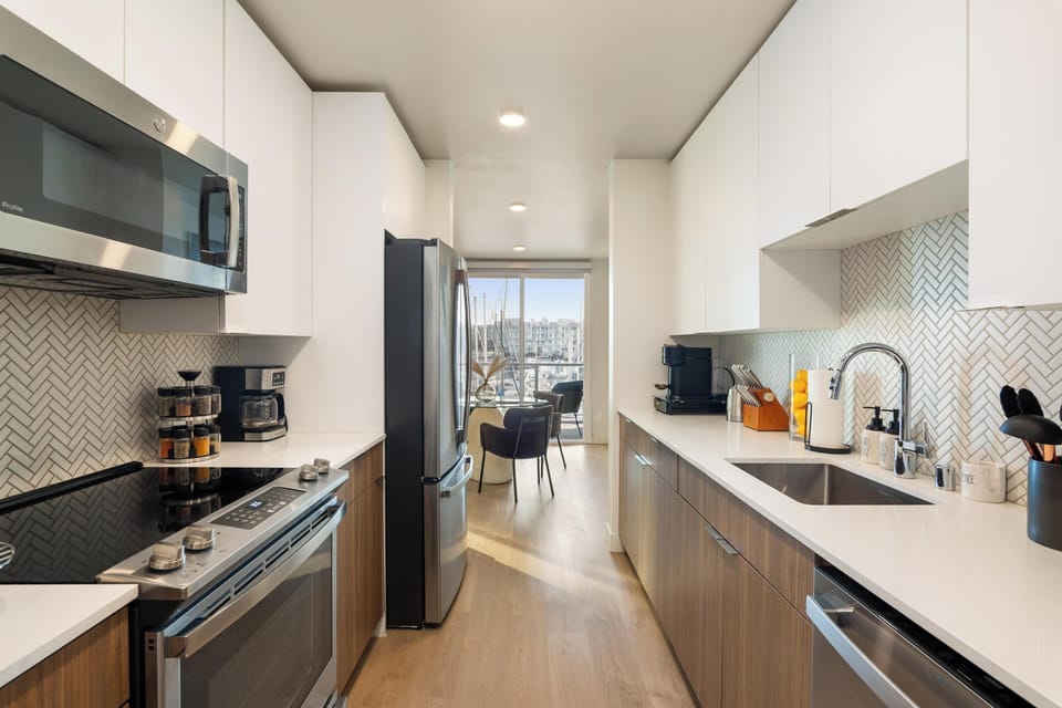 Kitchen (Wide) – Emphasizes the sleek, fully stocked layout.