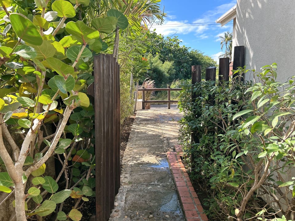 Private, quiet entrance lined with greenery.