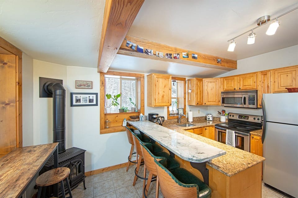 This cozy cabin kitchen is fully equipped with all you need to prepare memorable meals together | Lower Level