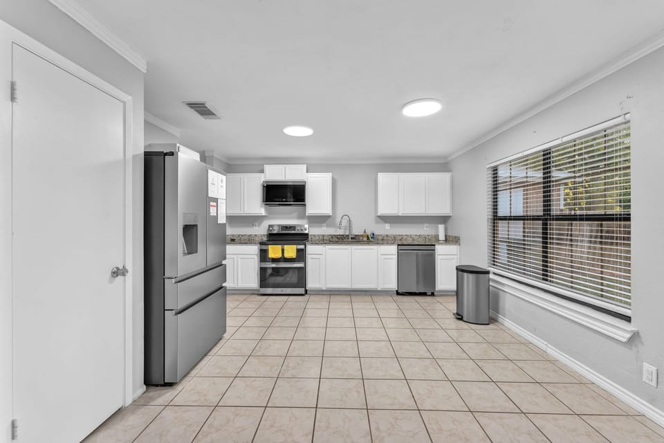 Spacious full kitchen with modern appliances & dining space.