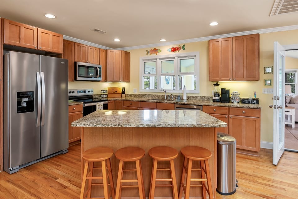 Gourmet open kitchen with all new stainless steel appliances and a view of the lake..