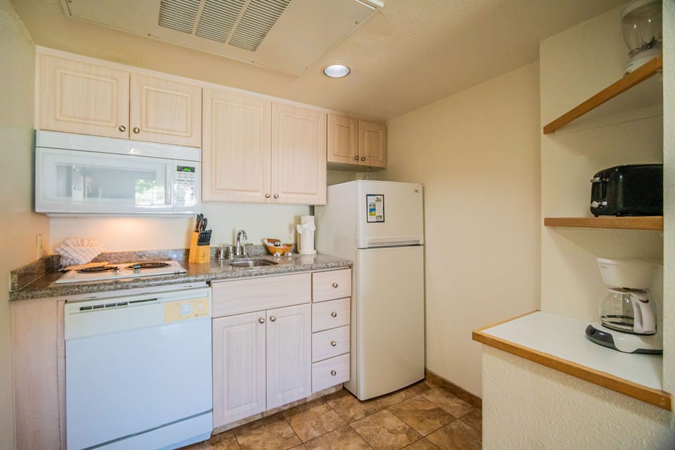 Step into a fully equipped kitchenette, designed for seamless meal preparation, allowing you to enjoy the comforts of home during your stay.