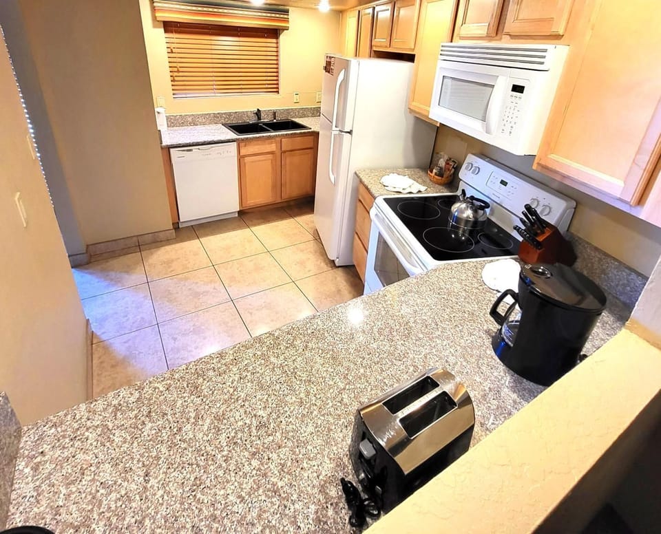 Functional Kitchen – A well-equipped kitchen showcasing modern appliances, ample counter space, and a practical layout.