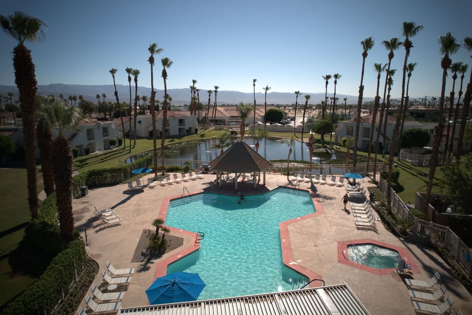 Enjoy a refreshing dip in the heated pools surrounded by stunning desert views, perfect for family gatherings and leisure days under the California sun.