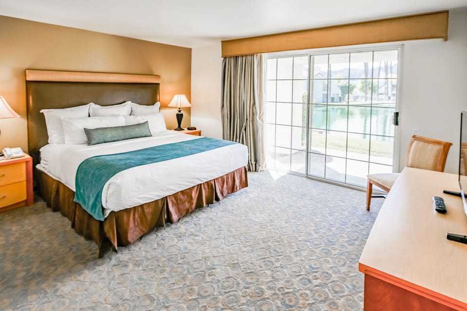 Spacious bedroom with a king bed and access to the outdoors, perfect for restful desert nights.