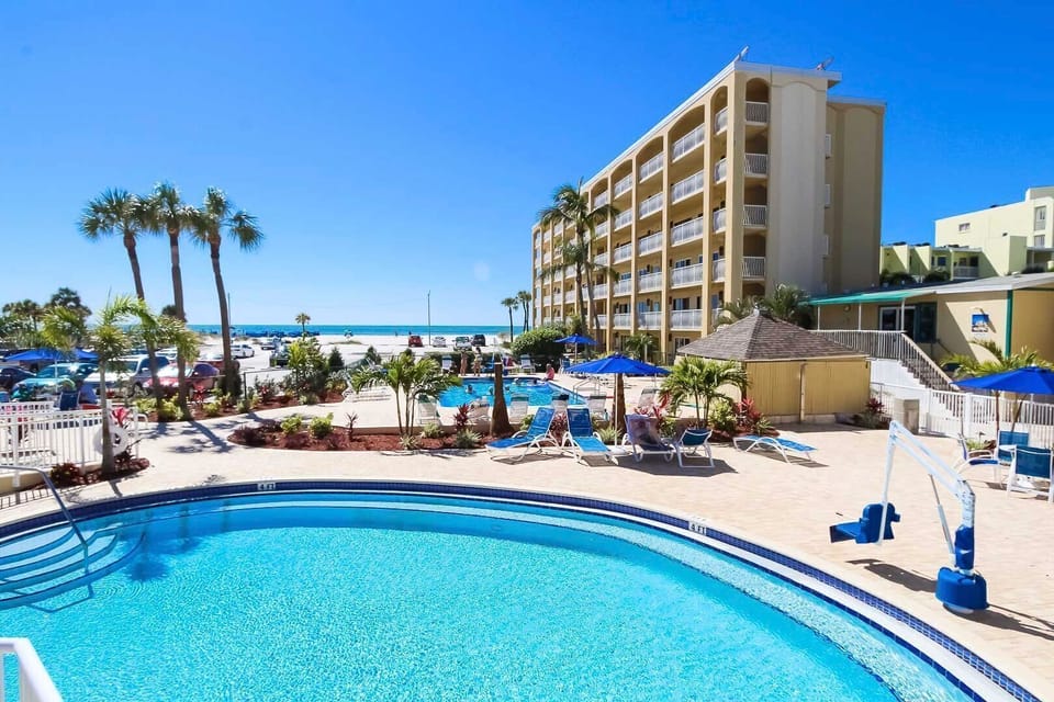 Relax by the pool while enjoying the stunning ocean view just steps away from your condo.