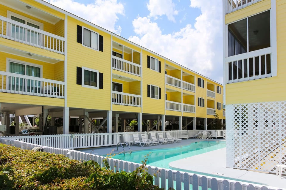 Experience resort-style living at Sandy Shores III with its inviting outdoor pool and well-maintained grounds, perfect for unwinding after a day at the beach.