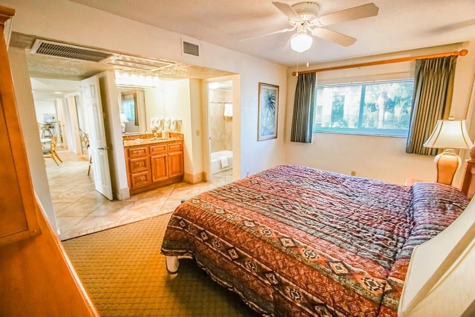 The spacious master bedroom features a comfortable king bed and direct access to a full bathroom, perfect for unwinding after a long day.