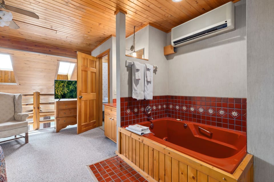 Relax in the spacious bathroom featuring a cozy jetted tub, perfect for unwinding after a long day.