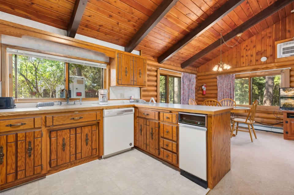 Rustic-style kitchen with wood cabinetry, modern appliances, and a bright open layout.