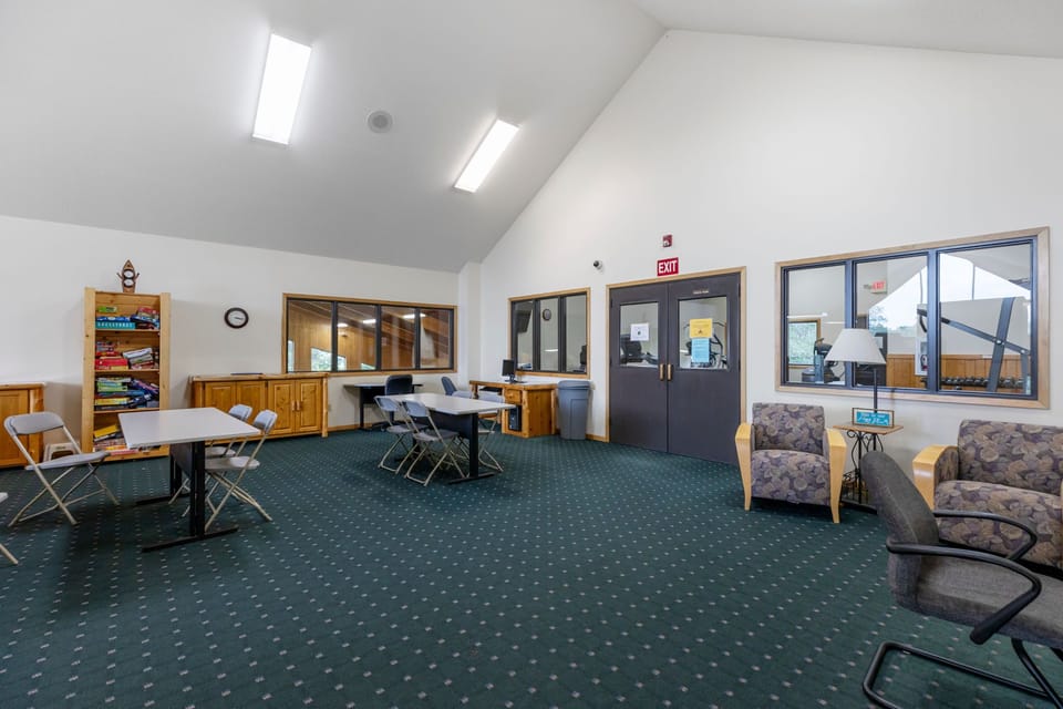 Multi-purpose room featuring ping pong, seating, and space for gatherings or recreation.