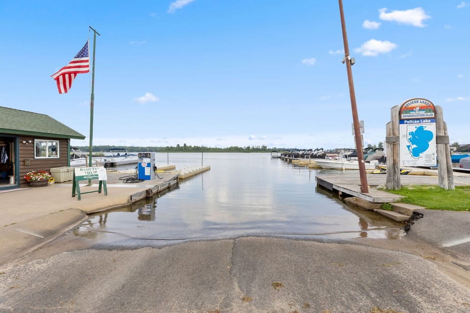 Lodge marina entrance with American flag and boat launch.