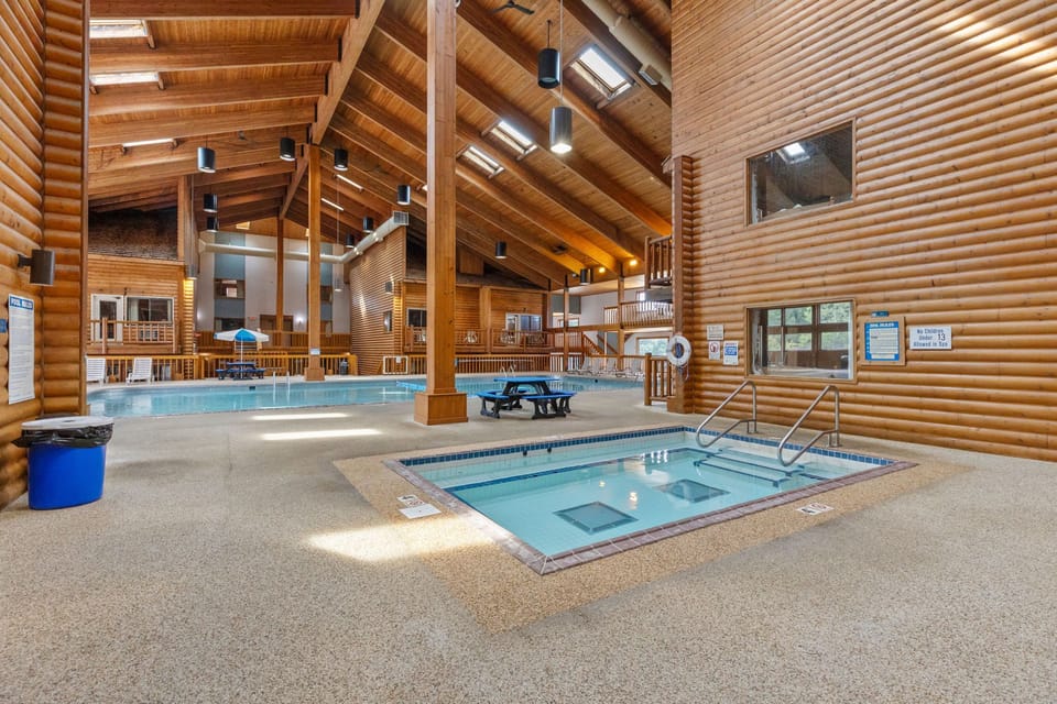 Indoor whirlpool area with rustic wood finishes and natural light.