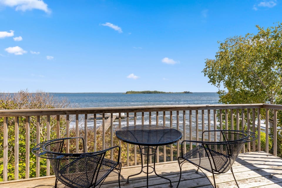 Private deck with outdoor dining and sweeping lake views.