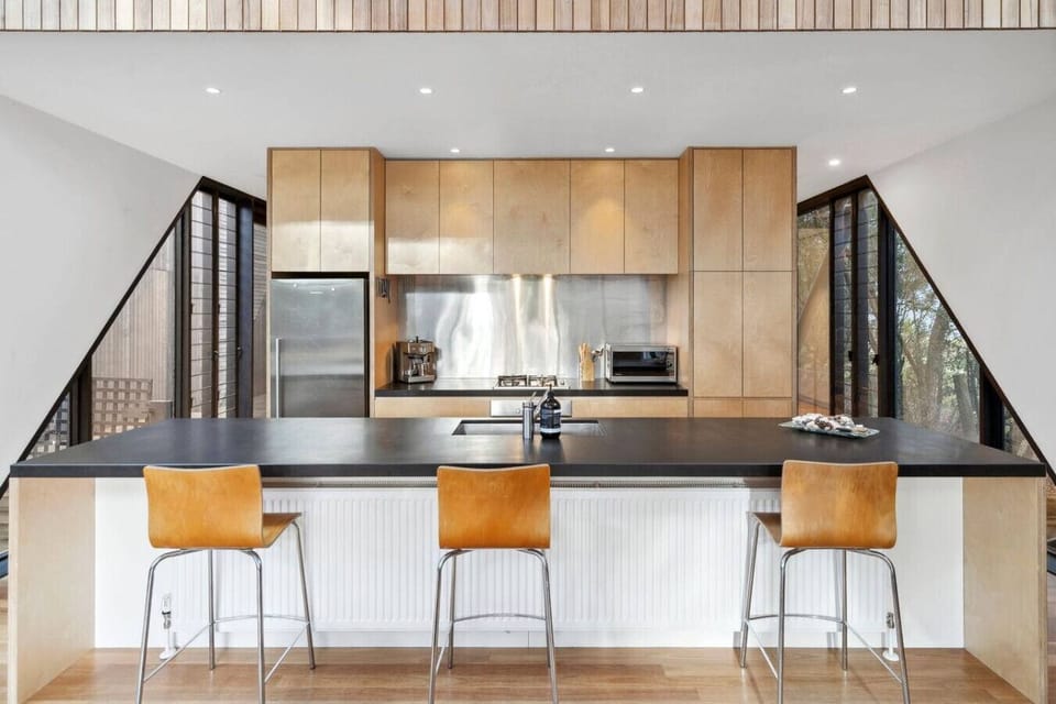 A peaceful space for morning coffee, BBQ dinners, and family gatherings surrounded by lush greenery.