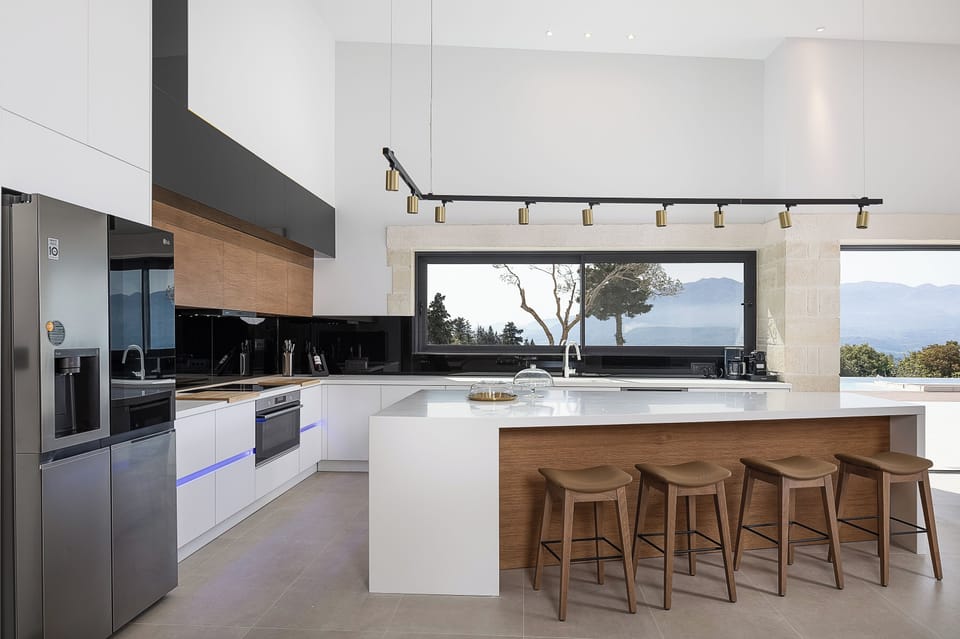 The fully equipped kitchen features premium BOSCH appliances, a wine cooler, and all the essentials for a seamless self-catered stay.