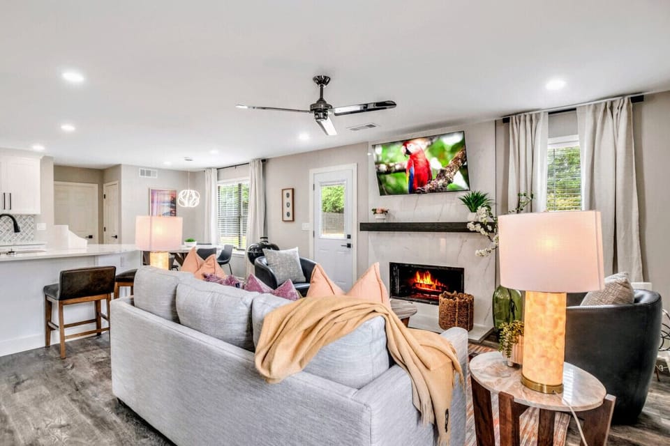 Living Room w/ SmartTV and partial view of Dinette area and Kitchen
