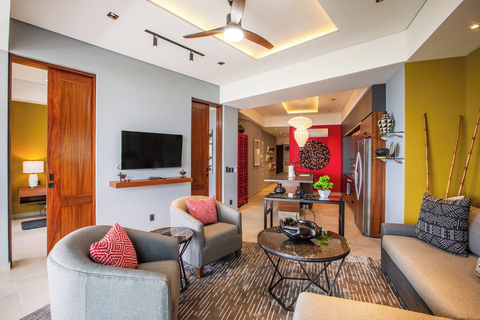 Living Room — The stylish living room has comfortable seating, smart TV and access to the private balcony