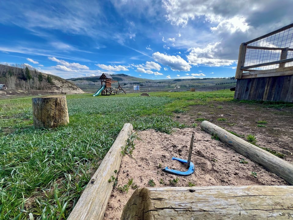 The the yard of the Hitchin' Post is ready with horseshoes and room to roam.