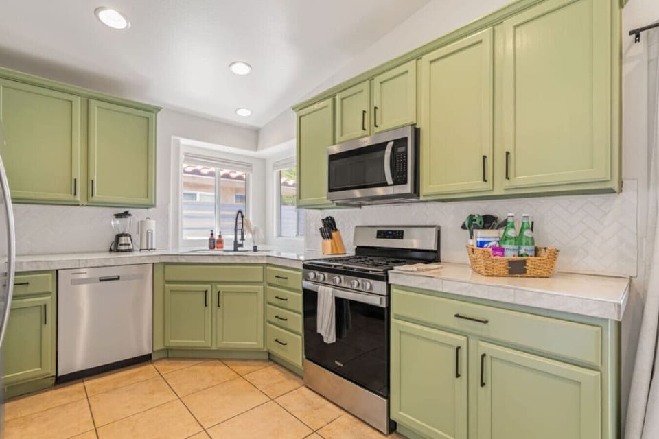 Cheerful kitchen w/ mint cabinetry, full appliances & plenty of counter space for easy meals.