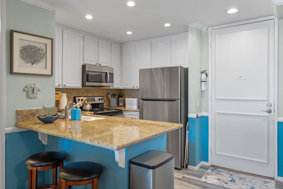 Two additional bar stools at the kitchen counter offer the perfect seating—especially for younger guests.