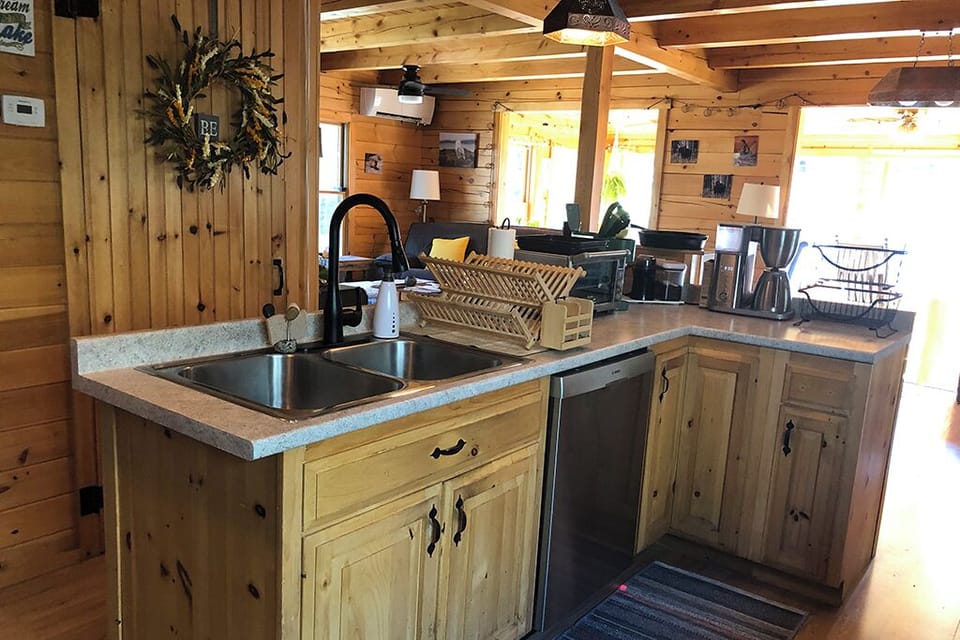 Kitchen is stocked with common spices, condiments, and supplies.